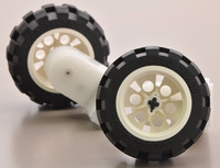 2mm shaft adapters connecting a LEGO wheels to 120:1 mini plastic gearmotors with offset output.