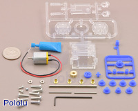 Parts included with the Tamiya 70190 mini motor multi-ratio gearbox (12-speed) kit with quarter for size reference.