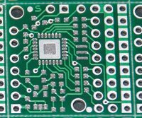 Close-up view of a circuit board with solder paste printed using a mylar stencil.