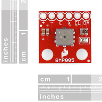 BMP085 barometric pressure sensor breakout board, with rulers for size reference.
